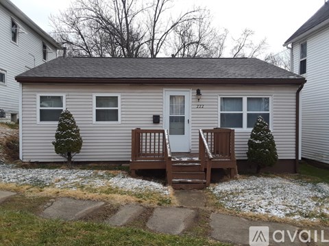 A house with a white door and a brown porch.