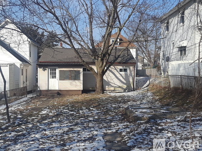 A house with a tree in front of it.