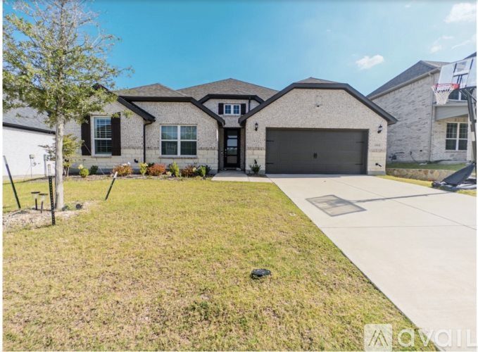 A house with a garage and a driveway is for sale.