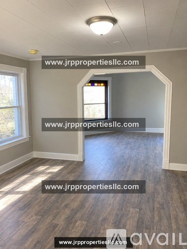 A room with wooden flooring and a window is available for rent.