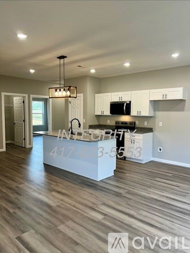 A modern kitchen with a countertop and cabinets.