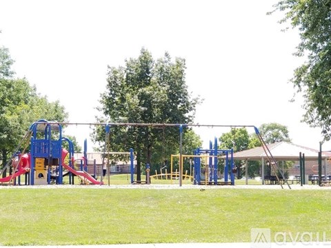 A playground with a blue and red slide.
