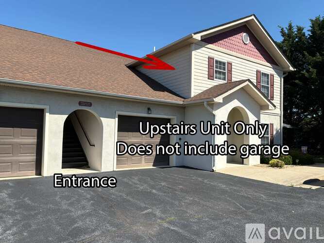 A house with a red arrow pointing to the roof and text indicating the upstairs unit does not include a garage.