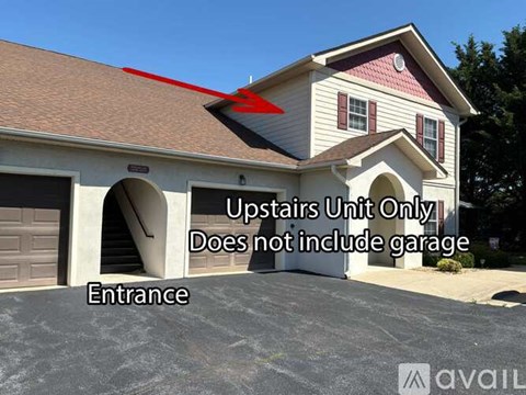 A house with a red arrow pointing to the roof and text indicating the upstairs unit does not include a garage.