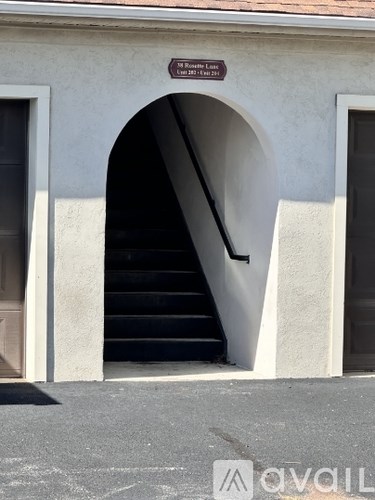 A staircase leading to a doorway under an archway.