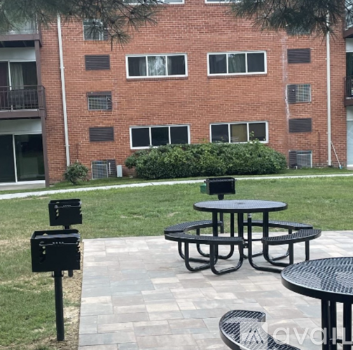 A black metal table sits in front of a brick building.