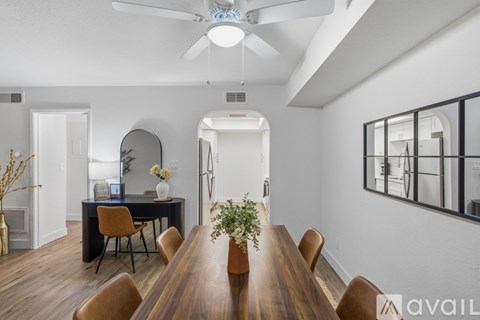 A dining room with a wooden table and chairs.