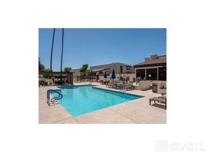 A pool with a blue water and a chair around it.
