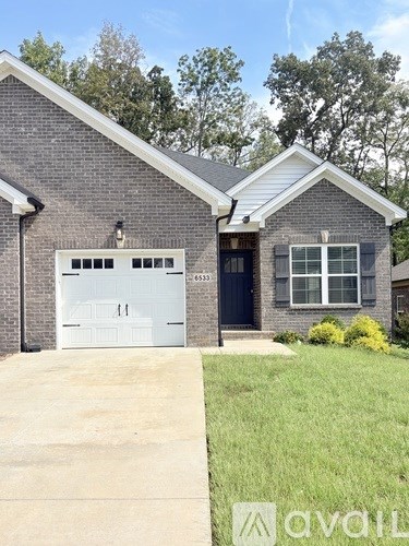 A house with a garage door and a window is for sale.
