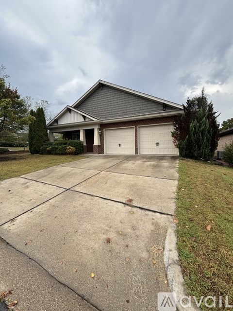 A house with a grey roof and two garages.
