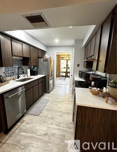 A kitchen with a dishwasher and a refrigerator.