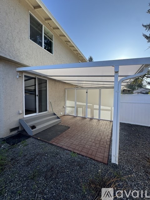 A house with a patio and a white pergola.