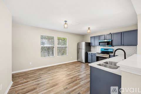A kitchen with wooden floors and a white counter top.