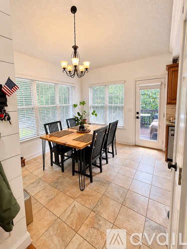 A dining room with a table set for six.