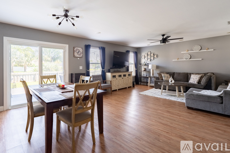 A living room with a dining table and chairs.