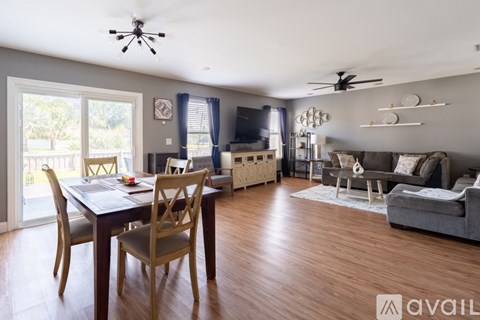 A living room with a dining table and chairs.