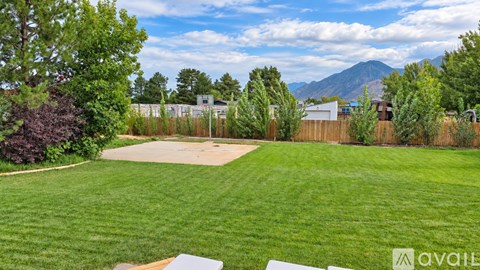 A backyard with a swimming pool and a mountain in the background.