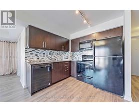 A modern kitchen with wooden cabinets and stainless steel appliances.