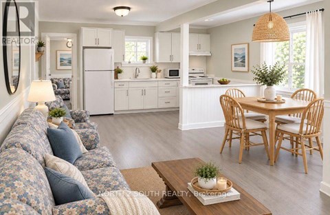 A well-lit kitchen and living room with a floral sofa.