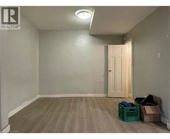 A room with a door and a light on the ceiling.