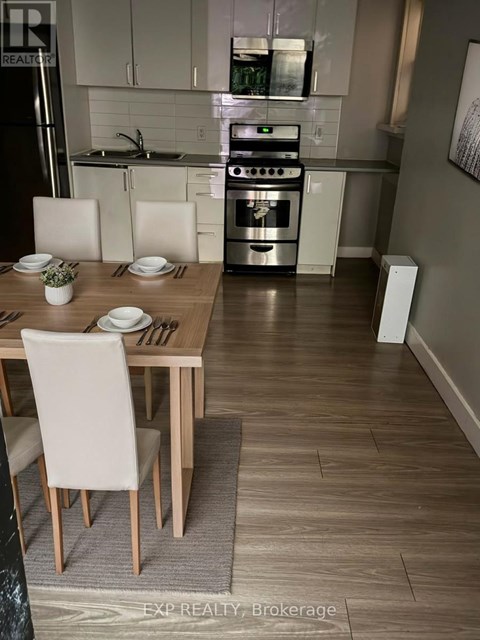 A modern kitchen with a dining table set for two.