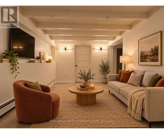 A living room with a red chair, a grey couch, and a coffee table.