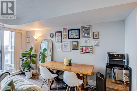 A dining room with a wooden table and chairs.
