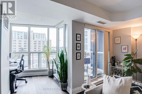 A well-lit office space with a view of the cityscape outside the large windows.