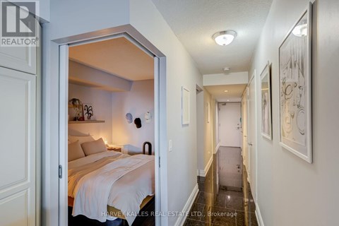 A bedroom with a bed and a mirror on the wall.