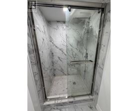 A marble bathroom with a walk in shower.