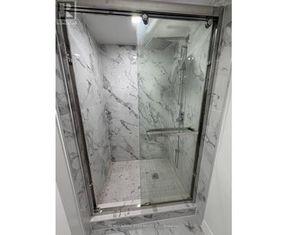 A marble bathroom with a walk in shower.