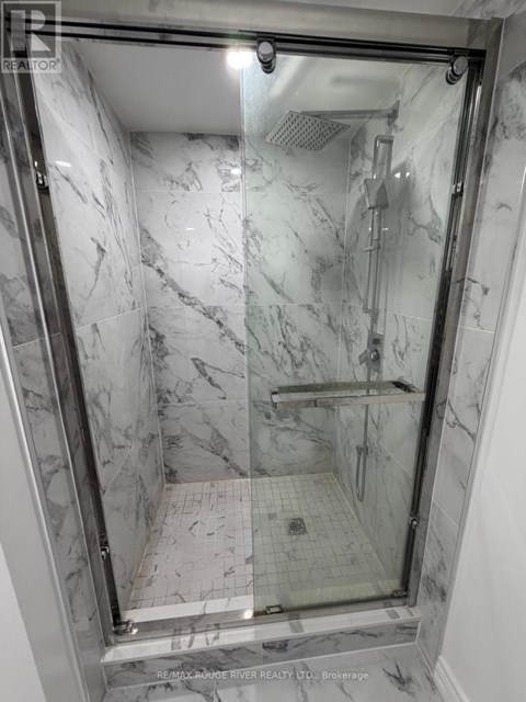 A marble bathroom with a walk in shower.