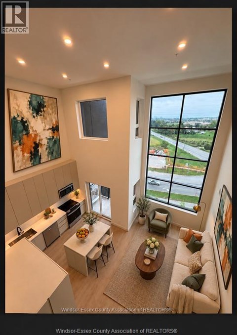 A living room with a view of the street outside the window.