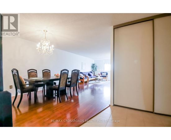 A dining room with a table and chairs.