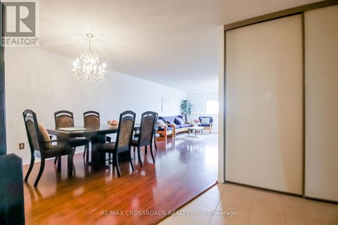 A dining room with a table and chairs.