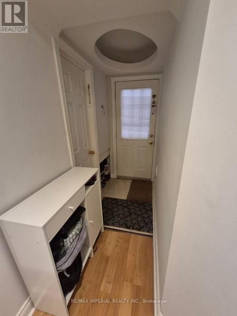 A hallway with a white door and a white cabinet.