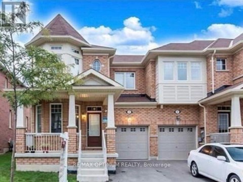 A two-story house with a white car parked in front.