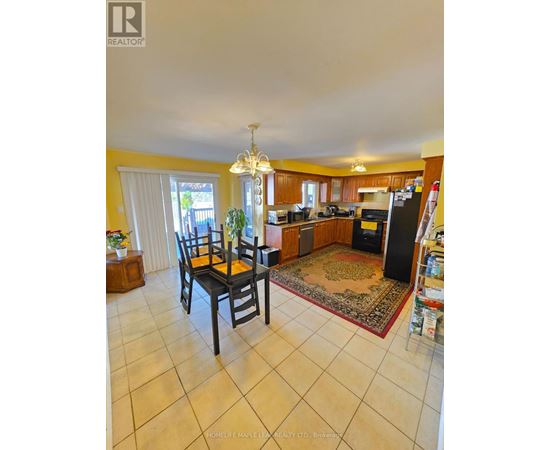 A kitchen with a dining table and chairs.