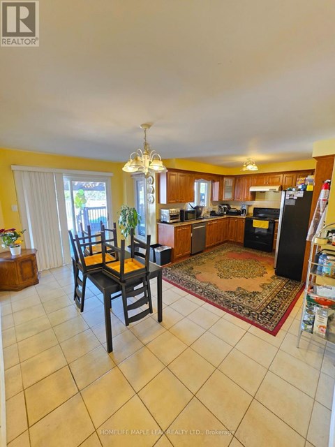 A kitchen with a dining table and chairs.