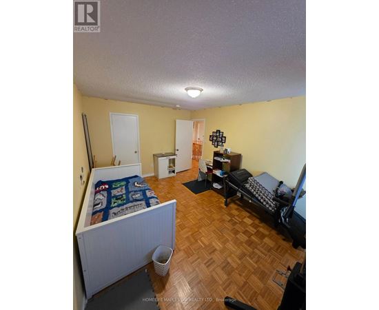 A bedroom with a bed and a couch.