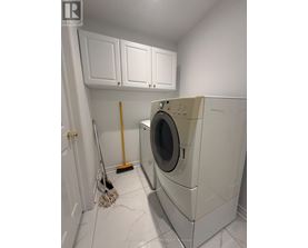 A white washing machine in a laundry room.