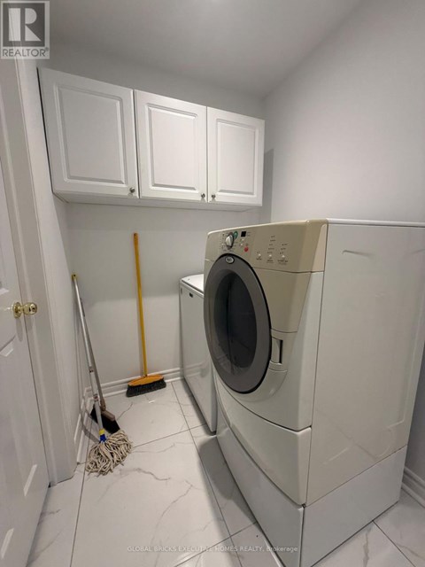 A white washing machine in a laundry room.