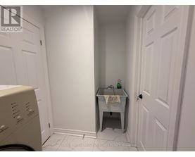 A small bathroom with a washer and dryer.