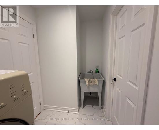 A small bathroom with a washer and dryer.