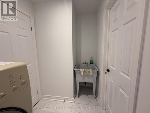 A small bathroom with a washer and dryer.