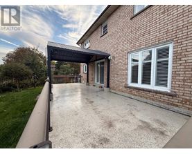 A house with a driveway and a covered walkway.