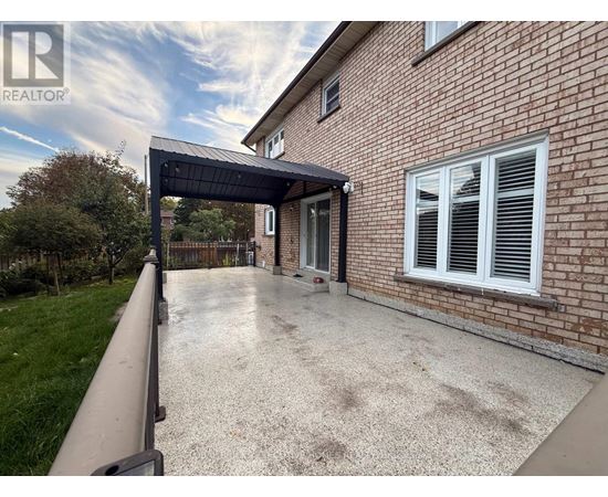 A house with a driveway and a covered walkway.