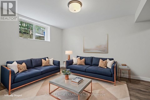 A living room with two blue couches and a coffee table.