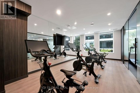 A gym with exercise bikes and a television.