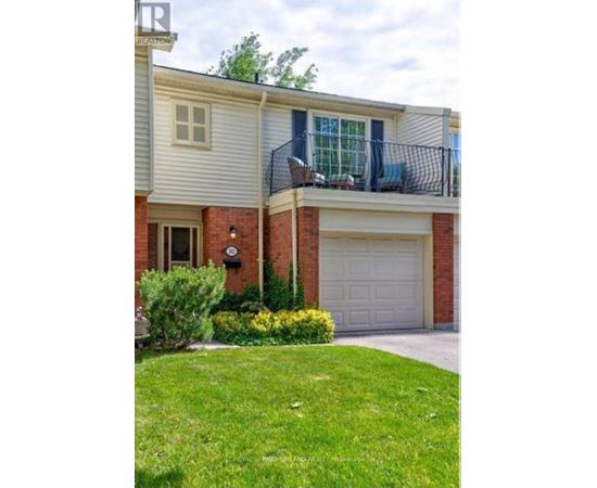 A house with a garage and a balcony with a railing.